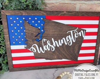 May include: Wooden sign featuring the state of Washington overlaid on a US flag design. The state outline is a dark wood color, with the word "Washington" in white script. The flag has red and white stripes and a blue field with white stars.