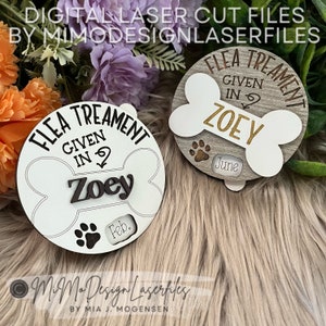 May include: Two white wooden dog bone shaped signs with the text "Flea Treatment Given In" and the name "Zoey". The signs have a paw print and a space for the month and year of the treatment. One sign has "Feb." and the other has "June".