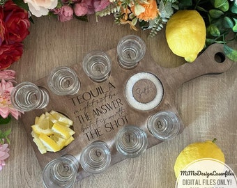 May include: A wooden shot glass tray with the text "TEQUILA might not be THE ANSWER but it is worth THE SHOT". The tray has eight shot glasses and a small salt dish. The tray is brown and has a handle.