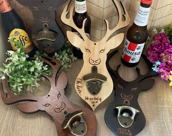 May include: Four wooden deer head bottle openers with a rustic brown, light brown, dark brown, and black finish. Each opener has a metal bottle opener with a brass finish and a personalized inscription. The inscriptions read "Oh deer... Another beer", "Oh deer... Take your head off here so", "Oh deer... It's 5 o'clock somewhere", and "Alex K. Larsen".