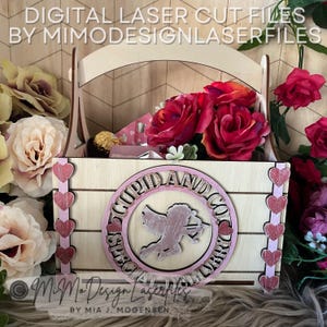 May include: A wooden box with a handle, decorated with pink hearts and the text "Cupid and Co. Special Delivery". The box is filled with red roses and a chocolate bar.