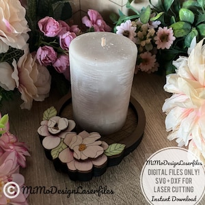 May include: A wooden candle holder with a floral design. The holder is decorated with pink and white flowers and green leaves. The holder is designed for laser cutting. The text "MiMoDesignLaserfiles" is visible in the image. "DIGITAL FILES ONLY! SVG+DXF FOR LASER CUTTING Instant Download" is also visible in the image.