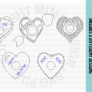 May include: Five different designs for Valentine's Day ornaments, each featuring a heart shape with a cutout in the center. The designs include "I Love You", "Love", "Happy Valentine", and two with "XOXO".