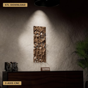 May include: A dark brown wooden wall art panel with a distinctive, open-cell pattern. The vertical rectangular piece features irregular cutouts. The text "STL DOWNLOAD" and "3-AXIS CNC" are displayed on the image.