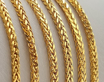 May include: Five gold chains with a braided design. The chains are arranged in a row, with the ends of the chains overlapping.