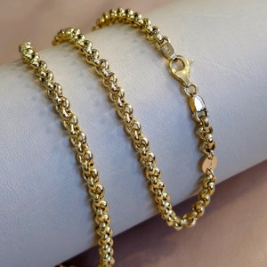 May include: A gold chain necklace with a lobster clasp. The chain is made of small, round links that are twisted together.