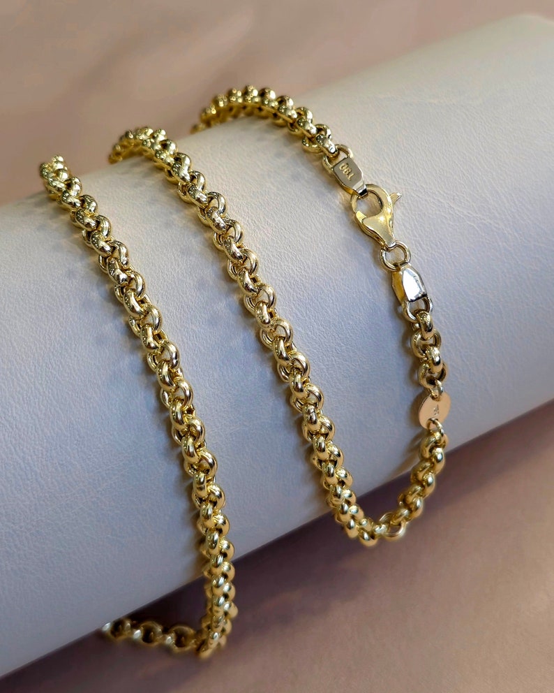 May include: A gold chain necklace with a lobster clasp. The chain is made of small, round links that are twisted together.