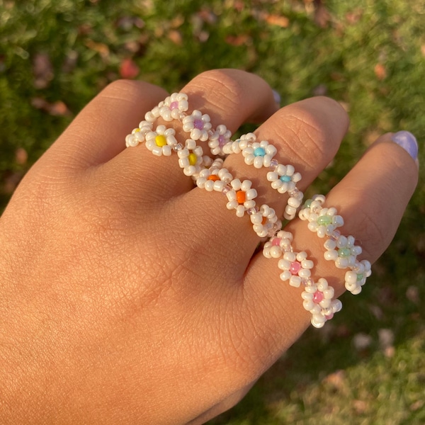 Pastel rainbow beaded rings with white flowers