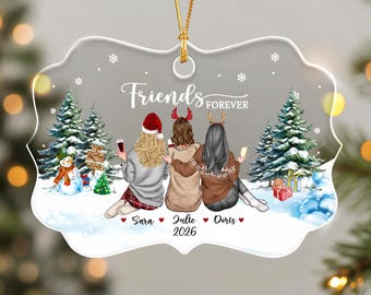 May include: A clear, scalloped-edge ornament featuring an illustration of three people from behind, wearing winter clothing and reindeer headbands. The text reads Friends FOREVER, Sara, Julie, Doris, and 2026. The scene includes pine trees, a snowman, and gifts.