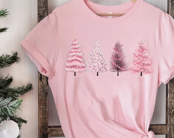 May include: Pink t-shirt with a graphic of five pink Christmas trees with white lights.