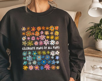 May include: Black sweatshirt with a colorful flower design and the text "Celebrate Minds of All Kinds".