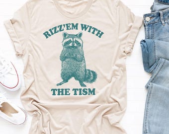 Rizz Em With The Tism Raccoon Shirt: Autism Awareness Cotton Tee