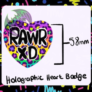 May include: A holographic heart-shaped badge with a leopard print background. The badge says "RAWR XD" in black letters. The badge is 5.8 cm wide.