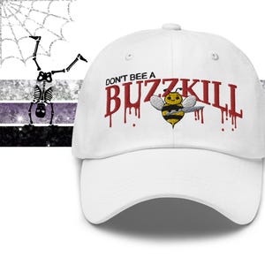 May include: White baseball cap with the text "DON'T BEE A BUZZKILL" in red, featuring a cartoon bee. The cap has a curved peak and a button on top. The design is embroidered.
