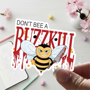 May include: A sticker featuring a cartoon bee with a menacing expression, holding a bloody knife. The text "DON'T BEE A BUZZKILL" is above the bee in red letters. The bee has black and yellow stripes and white wings.