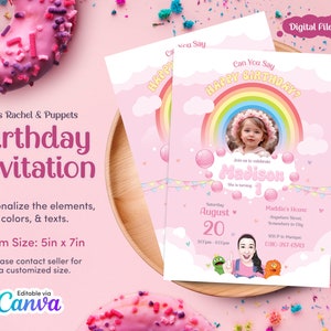 May include: Pink birthday invitation with a rainbow, clouds, and a photo placeholder. The text says "Can You Say Happy Birthday?" and "Join us to celebrate Madison. She is turning 1."