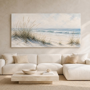 Könnte beinhalten: Ein großes rechteckiges Wandbild mit einer Küstenlandschaft, das hohes Strandgras im Vordergrund, einen sandigen Uferbereich und einen ruhigen blauen Ozean mit sanften Wellen unter einem hellen Himmel zeigt, platziert über einem weißen Sofa.