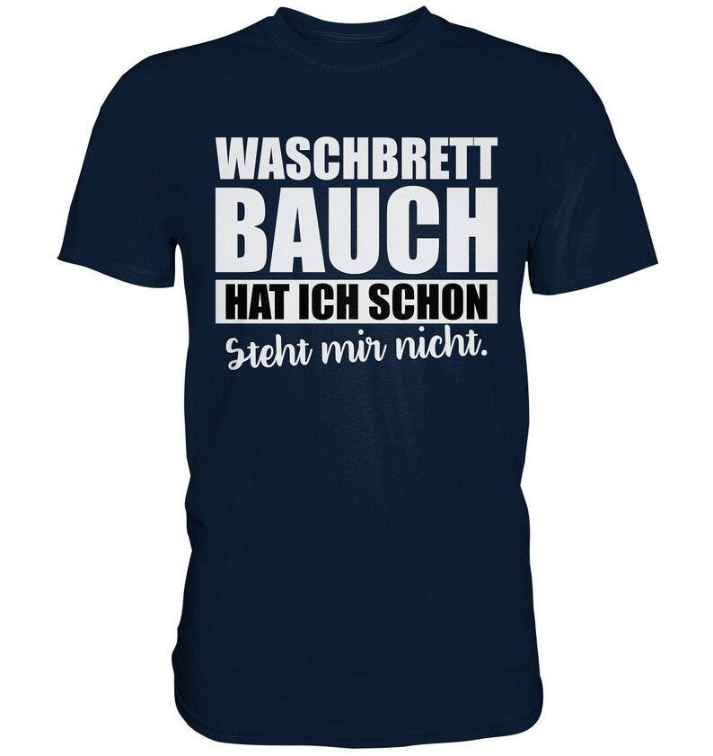 May include: Navy blue t-shirt with white text that reads "WASCHBRETT BAUCH HAT ICH SCHON Steht mir nicht." The shirt is a crew neck style and is made of a soft material.