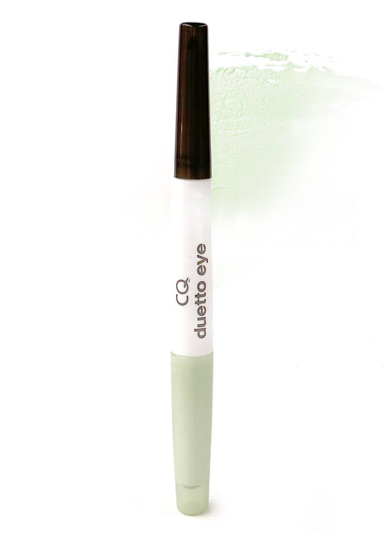 May include: A white and green dual-ended makeup stick with the text "CQ duetto eye" printed on the side.