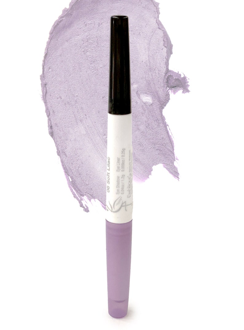 May include: A purple eyeliner pencil with a black cap and a white label that says "05 Soft Lilac Eye Liner." The label also says "Est&eacute;e Lauder 0.04 oz/1.25g."
