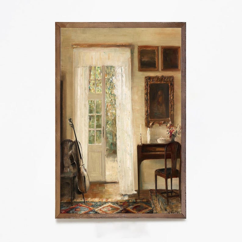 May include: An oil painting depicts a room with a cello, a table, and a doorway. The cello leans against a chair near a window with sheer curtains. A small table holds candles and flowers. The artwork is framed in a brown wooden frame.