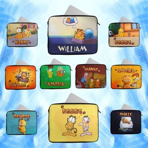 May include: A selection of laptop sleeves with Garfield the cat illustrations. Each sleeve displays a different name, including "Nancy", "William", and "Reggie". The sleeves have a black zip and are in various colours.
