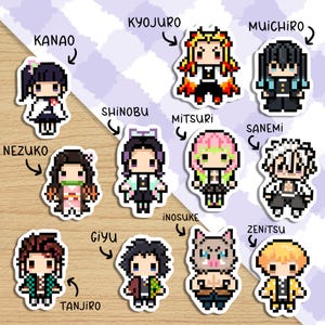 May include: A set of 12 Demon Slayer character stickers featuring pixel art designs. The stickers are printed on white, round, glossy paper with a black outline. The characters include Tanjiro, Nezuko, Zenitsu, Inosuke, Giyu, Shinobu, Mitsuri, Kyojuro, Muichiro, Sanemi, Kanao, and Aoi.