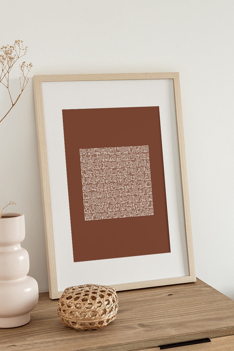 May include: A framed print with a brown background and a white geometric pattern. The frame is made of light wood.