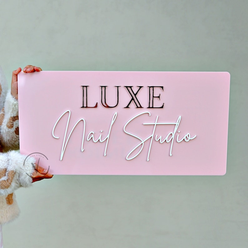 Custom Rectangle acrylic business sign in bubble gum pink backing, LUXE  in 3D rose gold acrylic on the top, Nail studio on 3D white acrylic under it in cursive font