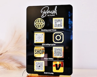 May include: Black acrylic sign with gold lettering and icons. The sign says "Brush by Crystal" and has QR codes for booking, social media, online shopping, and payment.
