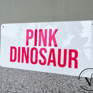 Custom Rectangle acrylic business sign in gloss white backing, PINK DINOSAUR in 3D hot pink acrylic on the sign using block sans font letter