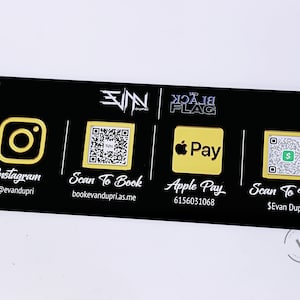 May include: Black sign with white text and yellow icons. The sign has four sections. The first section has an Instagram icon and the text "Instagram @evandupri". The second section has a QR code and the text "Scan To Book bookevandupri.as.me". The third section has an Apple Pay logo and the text "Apple Pay 6156031068". The fourth section has a QR code and the text "Scan To Pay $Evan Dupri".