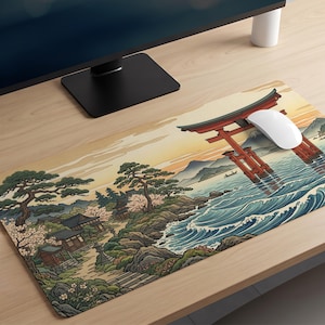 May include: A rectangular desk mat featuring a detailed illustration of a red torii gate standing in water, with waves, rocky shores, pine trees, and traditional buildings under a soft-toned sky, with a white computer mouse resting on top.