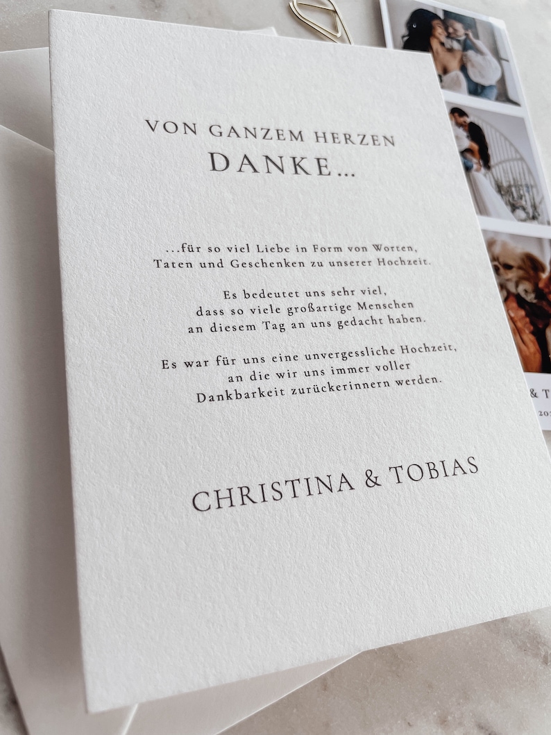 May include: A white card with black text that reads "Von Ganzem Herzen Danke..." followed by a message of thanks for the love, gifts, and support received at the wedding. The card is signed "Christina & Tobias".