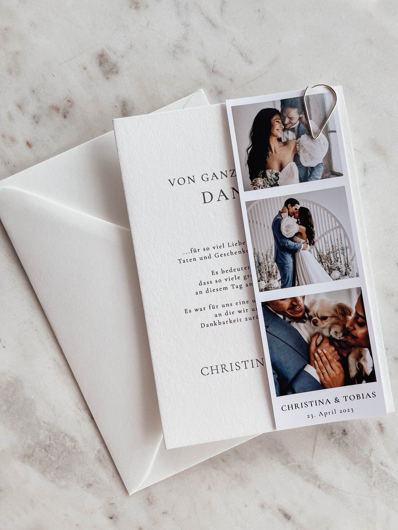 May include: A white card with the text "VON GANZ DAN" and a message of thanks for gifts and love. The card is decorated with three photos of a couple and their dog. The photos are in a Polaroid style and have a white border. The text at the bottom of the card reads "CHRISTINA & TOBIAS 23. April 2023."