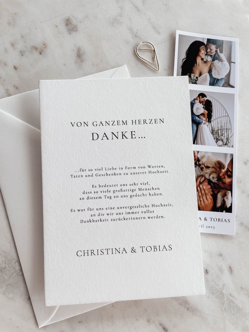 May include: A white card with black text that reads "Von ganzem Herzen Danke..." followed by a message of thanks for the love and support received at the wedding. The card also includes the names "Christina & Tobias" and the date "April 2023".