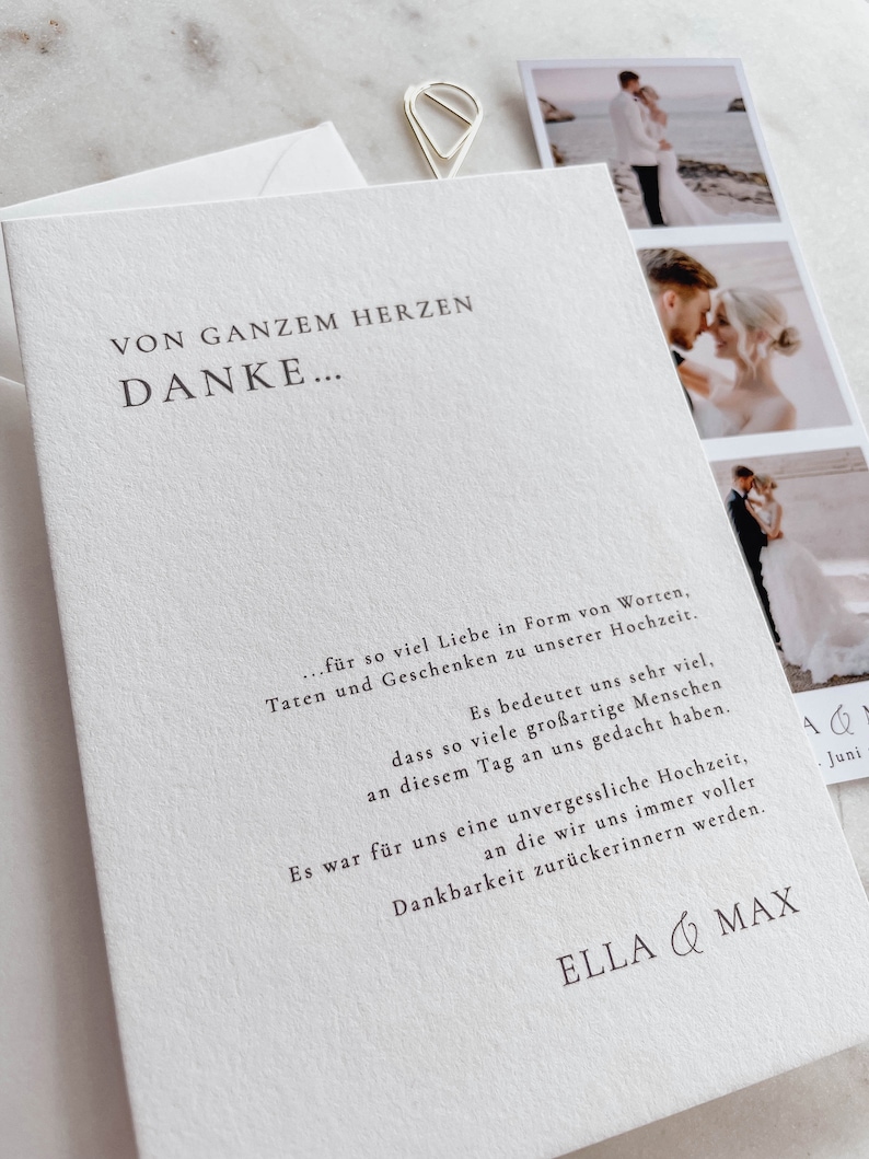 May include: A white thank you card with the text "Von Ganzem Herzen Danke..." and a message expressing gratitude for the love, gifts, and support received at a wedding. The card also includes the names "Ella & Max" at the bottom.