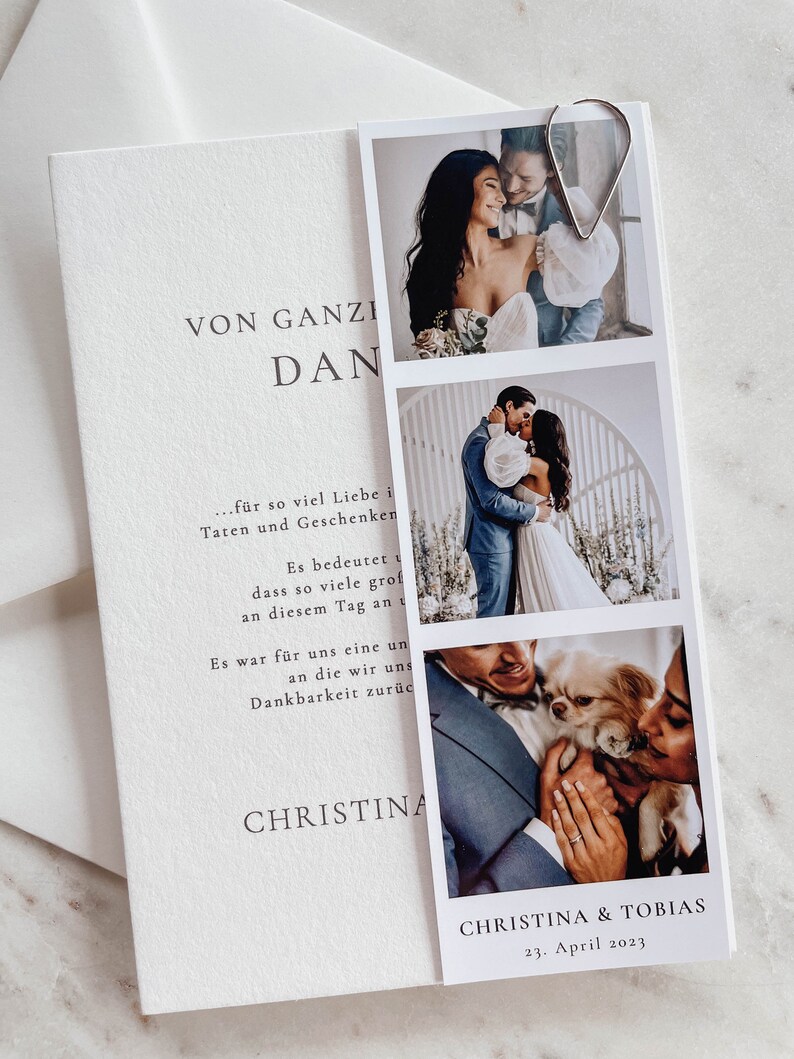 May include: A white card with a black and gray text that reads "VON GANZI DAN...f&uuml;r so viel Liebe in Taten und Geschenken Es bedeutet dass so viele gro&szlig; an diesem Tag an uns Es war f&uuml;r uns eine un an die wir uns Dankbarkeit zur&uuml;ck CHRISTINA CHRISTINA & TOBIAS 23. April 2023". The card has three photos of a couple and a dog.