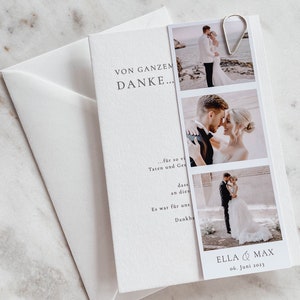 May include: A white card with the text "VON GANZEM DANKE..." and a photo collage of a wedding couple. The photos show the couple on a beach, kissing, and walking down the aisle. The card also includes the text "ELLA & MAX 06. Juni 2023".