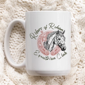 May include: White ceramic mug with a green and red design featuring a horse's head and the text "Riders of Rohan Equestrian Club".