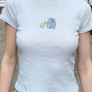 May include: A set of three ceramic mugs with a speckled, matte finish in cream, light grey, and dark grey. Each mug has a simple, minimalist design and a rounded handle.