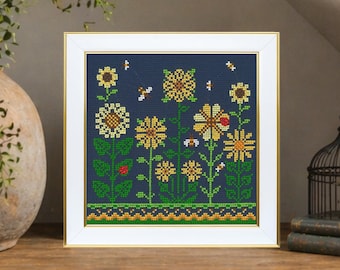 Kit de punto de cruz de girasoles, ideal para principiantes. Bordado floral sobre tela azul.