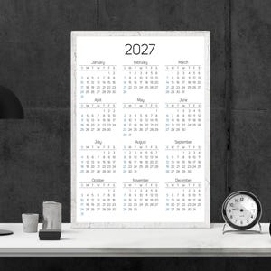 May include: A vertical wall calendar for the year 2027 featuring a clean white background with black text. The calendar displays all twelve months from January to December, organized in a grid format with clear headers for each month and day.