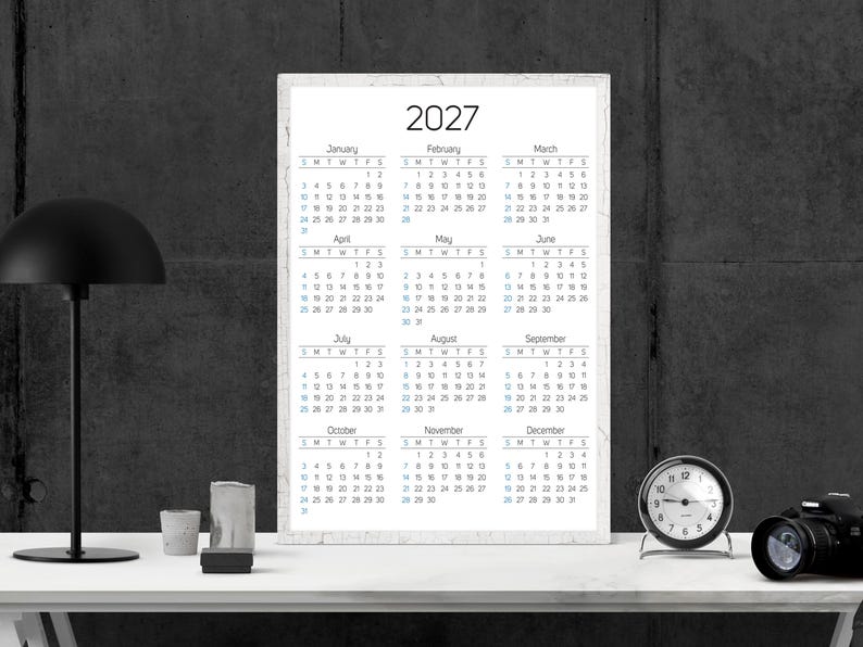 May include: A vertical wall calendar for the year 2027 featuring a clean white background with black text. The calendar displays all twelve months from January to December, organized in a grid format with clear headers for each month and day.