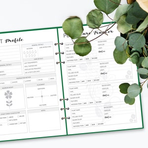 May include: A green and white plant care tracker journal with a plant profile section on the left page and a plant care tracker section on the right page. The journal has a spiral binding and is designed to help you keep track of your plants.