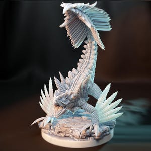 May include: A detailed, light gray fantasy figurine of a winged reptile creature. The creature has a long, textured body, feathered wings, and a detailed head with an open mouth. It is posed on a rocky base, with intricate detailing throughout.
