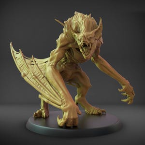 May include: A tan-coloured monster figurine with bat-like wings, sharp claws, and an open-mouthed expression. The creature is posed on a black circular base, showcasing intricate details and a menacing appearance. The figurine is likely a collectible or decorative item.