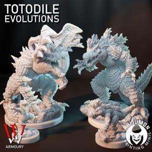 以下が含まれることがあります： 2体の詳細な灰色の恐竜フィギュア。フィギュアは戦闘ポーズで、鋭い歯ととげのある特徴があります。「TOTODILE EVOLUTIONS」の文字が上部にあります。「WV ARMOURY」と「KAIJUMON 3D PRINTING MINIS」のロゴが下部にあります。