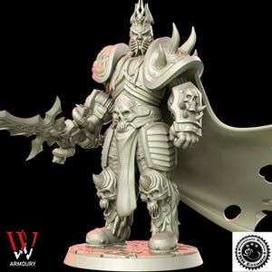 May include: A detailed, light-coloured figurine of a warrior in ornate armour, featuring skull motifs on the shoulders, gauntlets, and greaves. The figure holds a large, stylised sword and wears a cape. The base has the text "W Armoury".