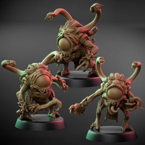 Puede incluir: Tres figuras de criaturas fantásticas marrones, cada una con un gran ojo central, múltiples tentáculos y dientes afilados. Las figuras están posadas sobre bases circulares negras, con una apariencia detallada y texturizada.